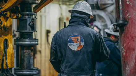 Drilling rig worker wearing a RP Drilling jacket.